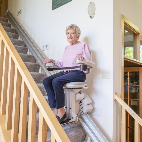 Bruno Elite stair lift itaking lady upstairs